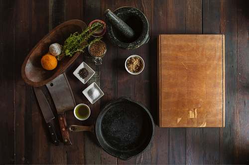 spices black mortar and pestle beside brown box in top view photography herbs