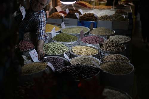 human close-up photo of seeds on sacks and bowls person