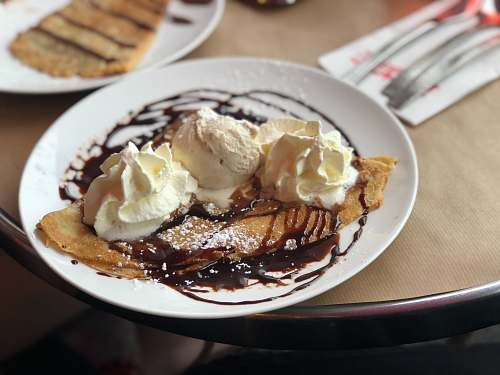 cream crepe with ice cream and syrup dessert