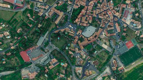 road aerial photography of city with houses aerial view