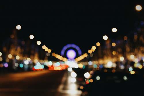 paris bokeh photography of lights on road during nighttime champs-élysées