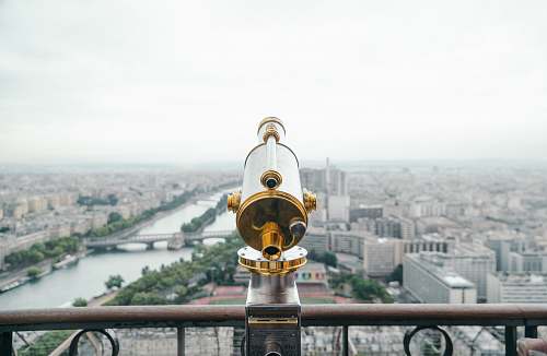 paris gray and gold-colored telescope on roof eiffel tower
