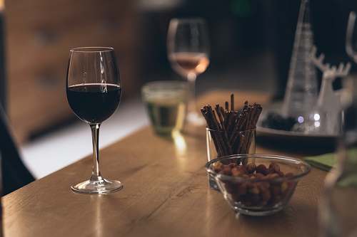 drink black liquid in clear wine glass on brown wooden table wine