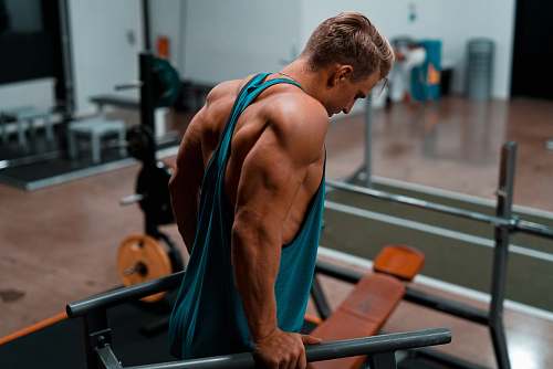 person man exercising in dip station people