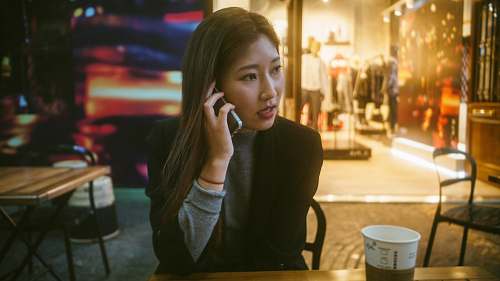 argentina woman talking on phone outdoor in front of store person