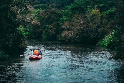 water people riding raft at the river near trees misiones