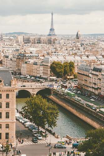 france group of people walking near body of water and building under blue sky at daytime city