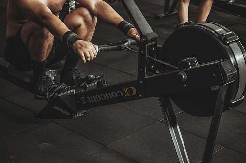 sport topless man using rowing machine exercise