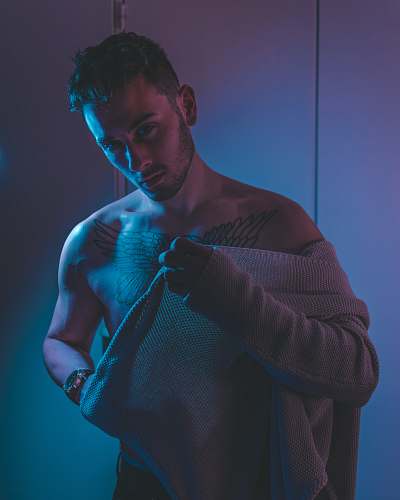 human man putting on sweater people