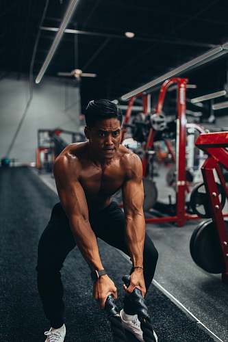 human muscled man holding two black ropes apparel
