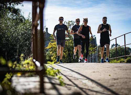 human three men running on road exercise