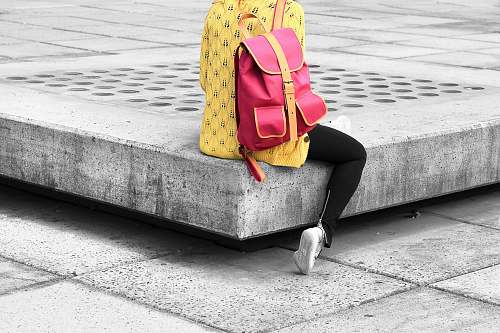 bag woman carrying pink backpack sitting on the edge concrete bracket city
