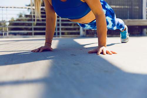 people woman planking on gray asphalt road human
