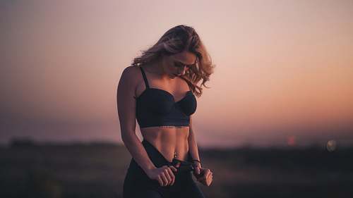 fitness woman standing on the field during sunset people