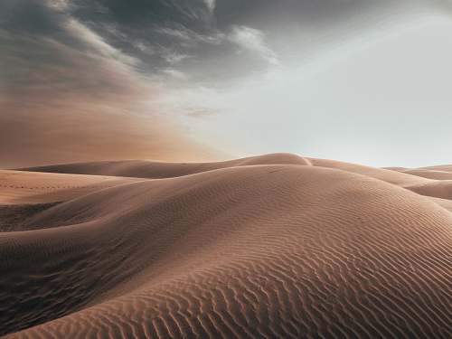 soil sand dunes at desert under grey cloudy sky nature
