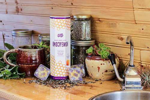 furniture honey container beside clear glass jars tabletop
