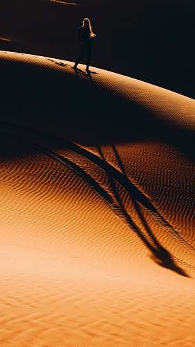 nature woman walking on desert sand