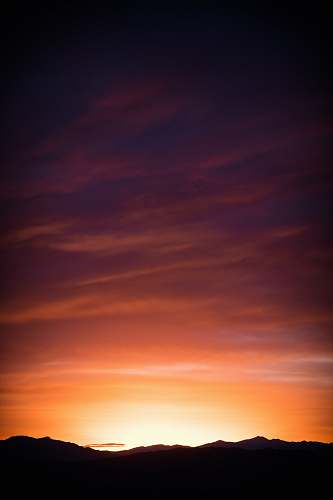 sky silhouette of mountains during orange sunset sunrise
