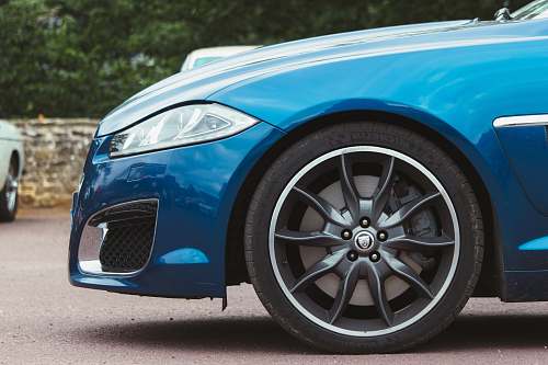 car The passenger side front tire on a blue car. machine
