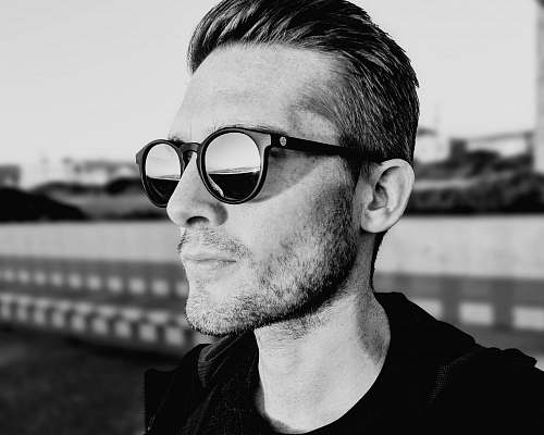 person grayscale photography of man wearing sunglasses people