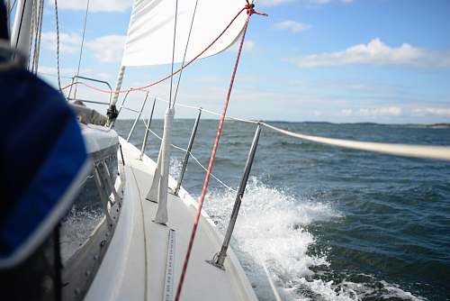 sailboat white and blue boat sailing on water during daytime finland