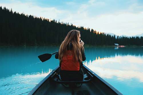 person blonde haired woman riding on boat people