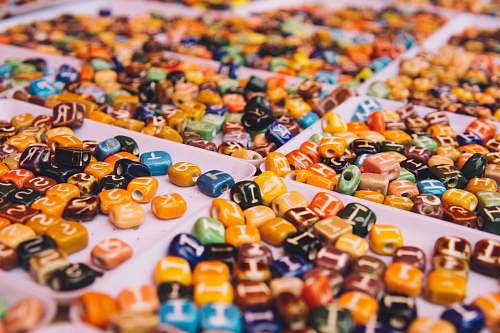 letter assorted-color bead lot on white tray abc