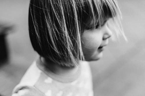 human photo of girl wearing gray crew-neck shirt black-and-white
