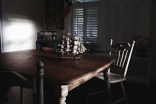 ship ship miniature on table chair