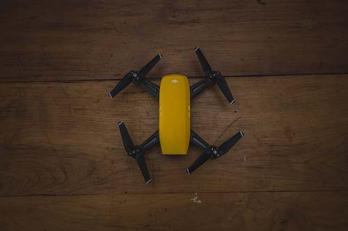 plywood yellow and black drone on wooden surface small