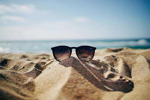 sunglasses black Ray-Ban Wayfarer sunglasses on beach sand beach wallpapers