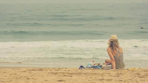 ocean woman sitting on seashore sea