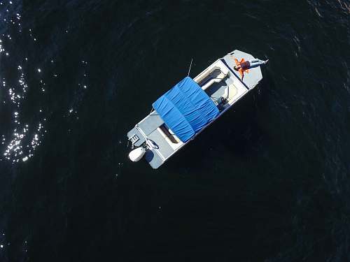 dinghy aerial photo of gray boat on body of water transportation