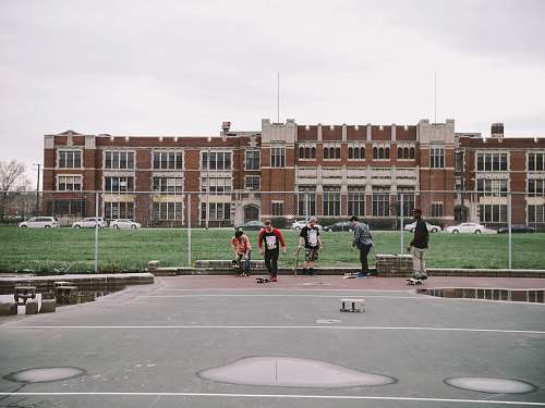 detroit group of people near brown building boys