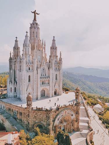architecture people walking near church during daytime steeple