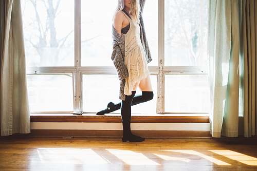 woman person standing beside window people