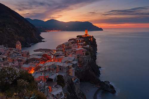 building aerial view of village on mountain cliff during orange sunset city