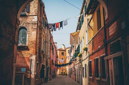 city clothes hanged across empty alley alleyway