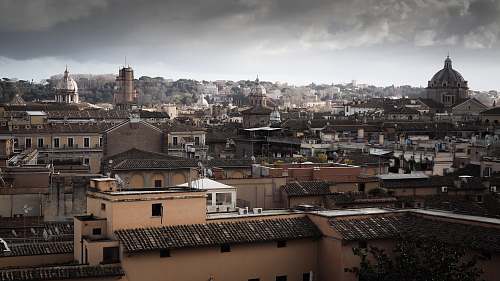 building concrete buildings under gray sky at daytime city