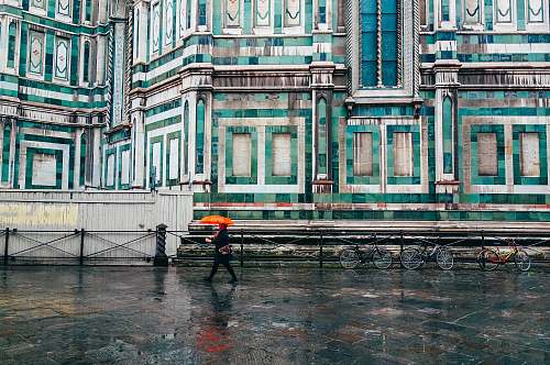 florence person holding umbrella walking on road rain