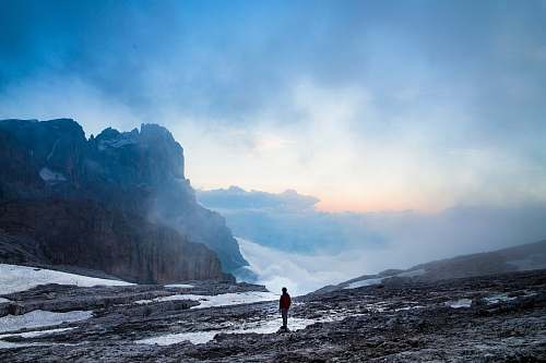 nature person standing near the cliff of the mountain snow