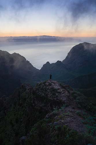 dawn person standing on rock monolith dusk