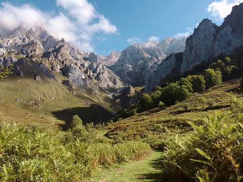 mountain mountain range with green grassy mountainside outdoors
