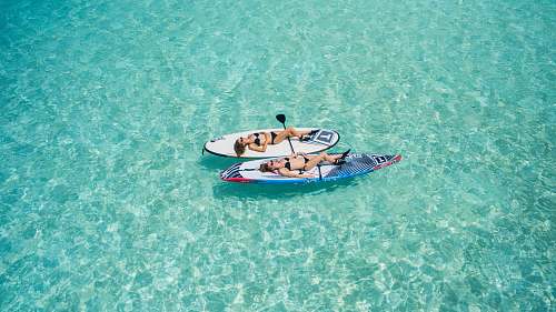 maldives two woman on surfboard floating on water water