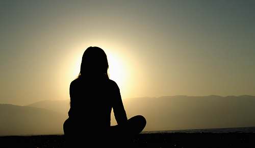 human woman sitting on sand meditation