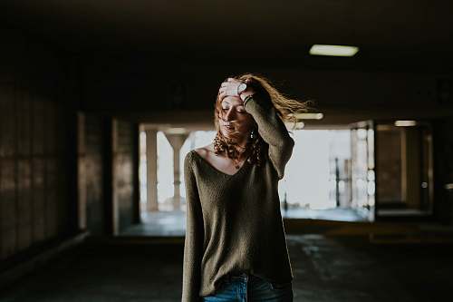 person woman walking oh street while holding forehead human