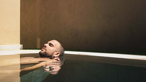 human man floating on water face