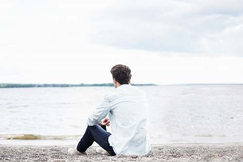 people man wearing white dress shirt near sea sea