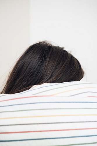 rest woman beside wall striped