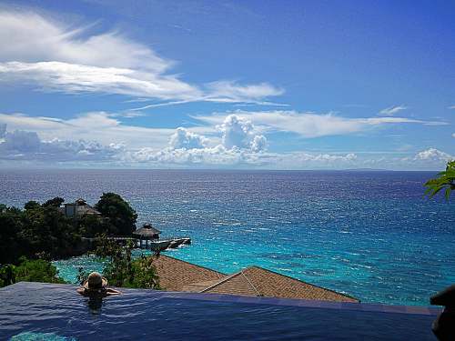 ocean beige roofed house beside sea view